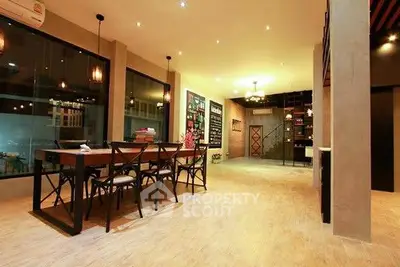 Spacious modern dining area with elegant lighting and large windows.