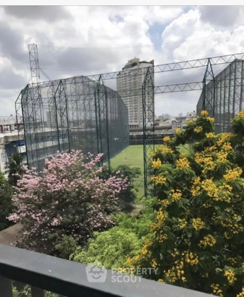 Scenic view of lush greenery and urban skyline from a balcony, perfect for nature lovers.