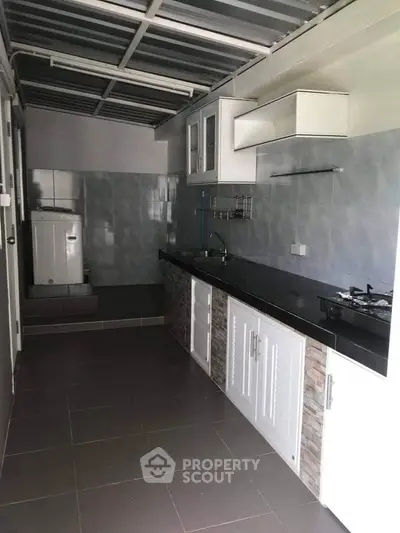 Modern kitchen with sleek countertops and gas stove in a stylish home.