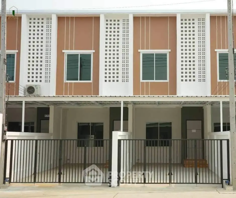Modern townhouse exterior with gated parking and stylish facade