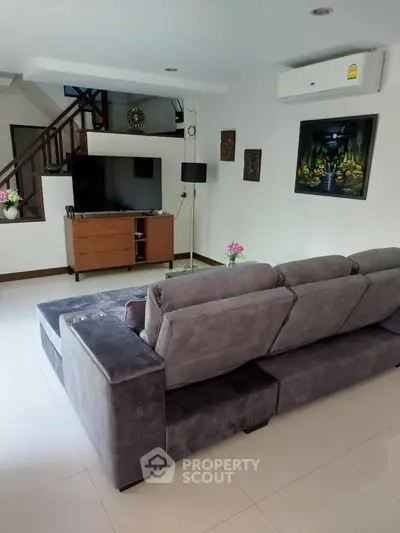 Spacious living room with modern decor and cozy seating area