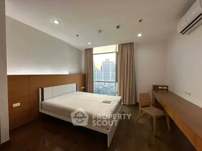 Modern bedroom with city view, featuring sleek wooden furniture and large window for natural light.