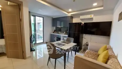 Modern living room with open kitchen, sleek furniture, and balcony access in a stylish apartment.