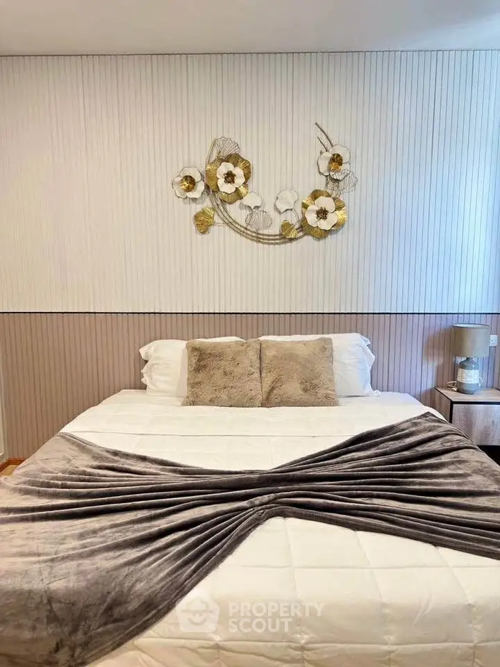 Elegant bedroom with stylish decor and cozy bedding in modern apartment.