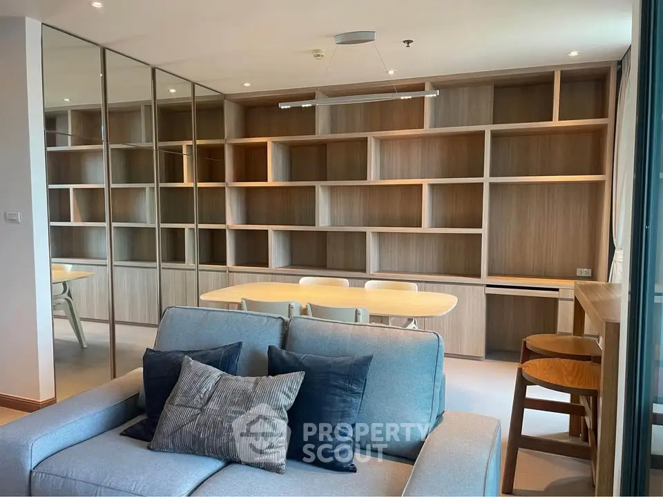 Modern living room with built-in wooden shelves and cozy seating area