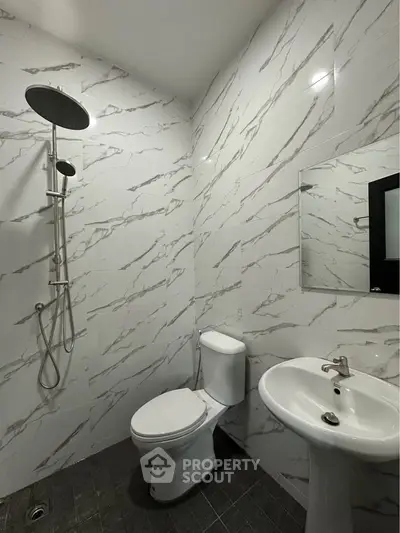 Modern bathroom with sleek shower and elegant marble tiles