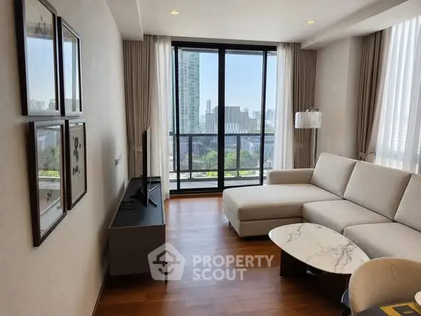 Modern living room with large windows and city view, featuring a stylish sofa and sleek decor.