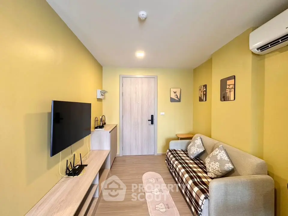 Modern living room with yellow walls, cozy sofa, and wall-mounted TV in stylish apartment.