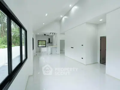 Spacious modern living room with large windows and open layout, perfect for natural light and contemporary living.
