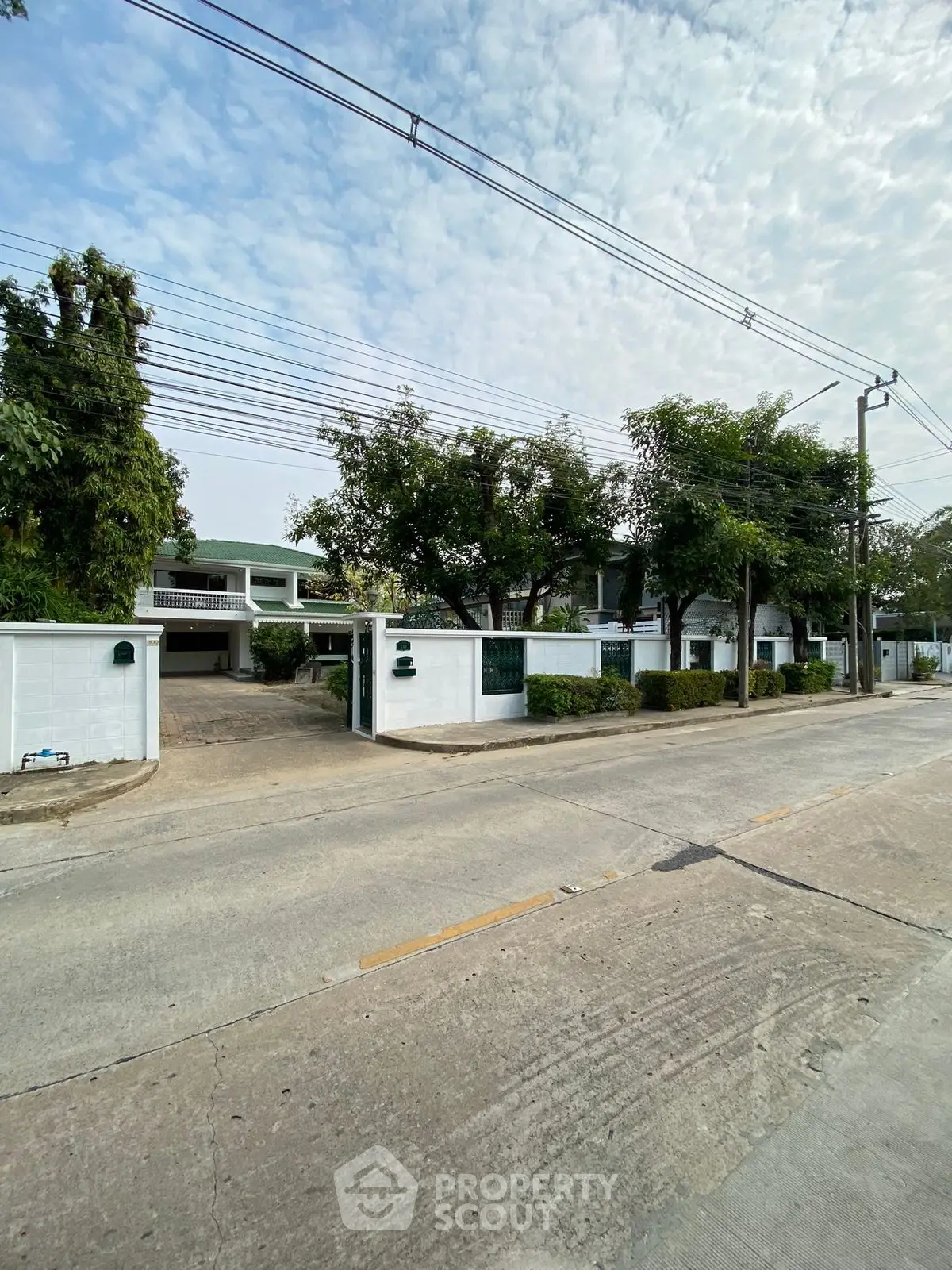 Charming suburban house with lush greenery and spacious driveway