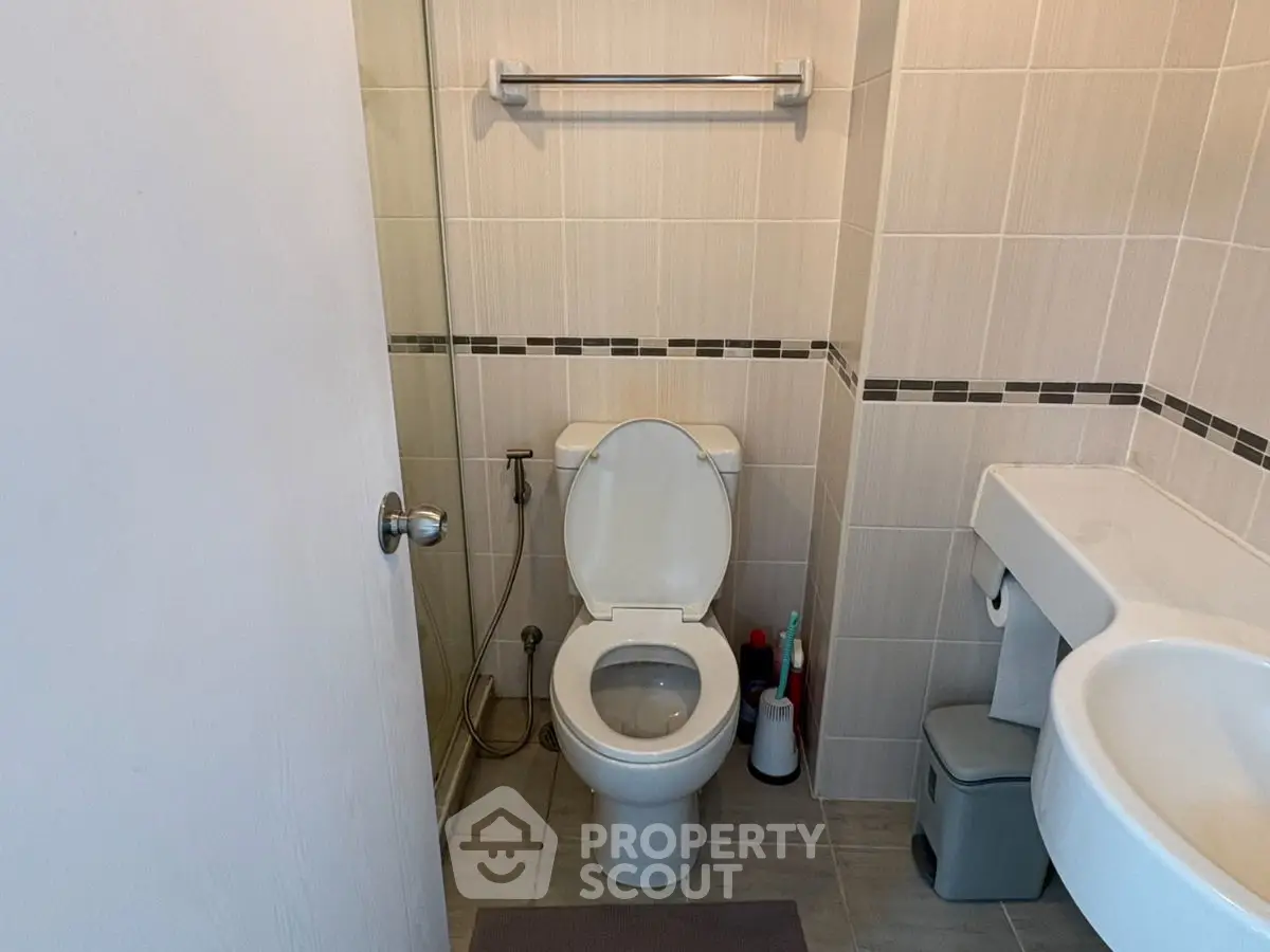 Modern bathroom with sleek fixtures and neutral tile design.