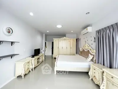 Spacious bedroom with elegant vintage furniture and modern amenities