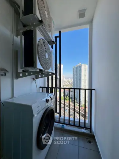 High-rise apartment balcony with city view and washing machine setup.