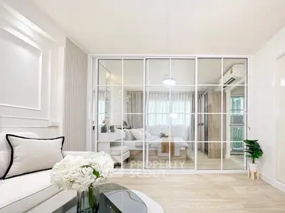 Modern living room with mirrored sliding doors and elegant decor