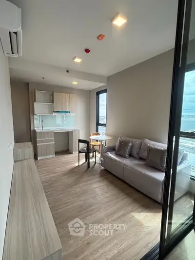 Modern living room with open kitchen and stunning city view