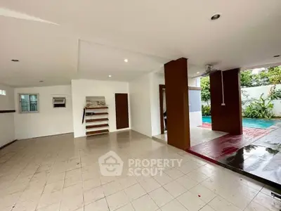 Spacious open-plan living area with pool view and modern design