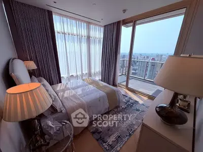 Luxurious bedroom with floor-to-ceiling windows and stunning city view from private balcony.