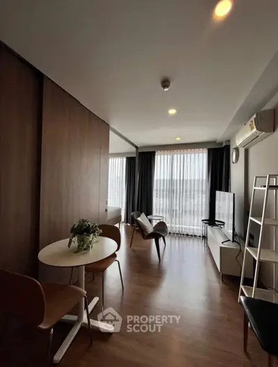 Modern living room with stylish furniture and large windows offering natural light.