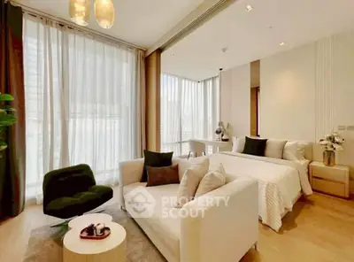 Luxurious modern bedroom with elegant decor and large windows in a high-end apartment.
