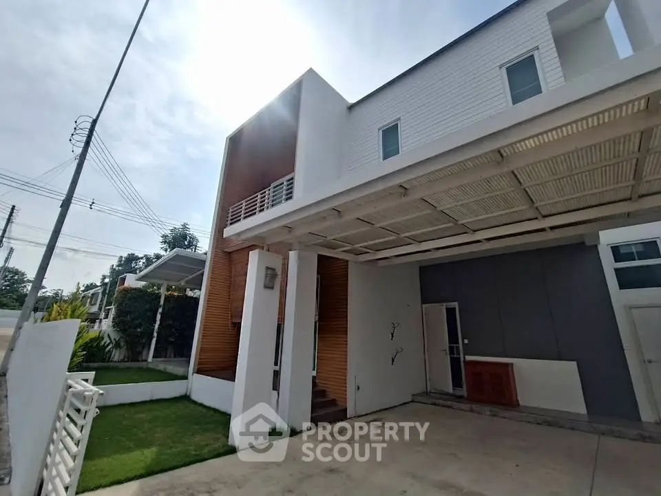 Modern two-story house with carport and minimalist design