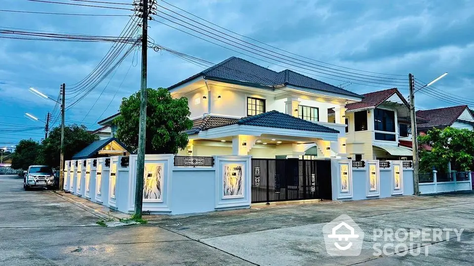 Stunning two-story house with modern lighting and spacious driveway in a serene neighborhood.