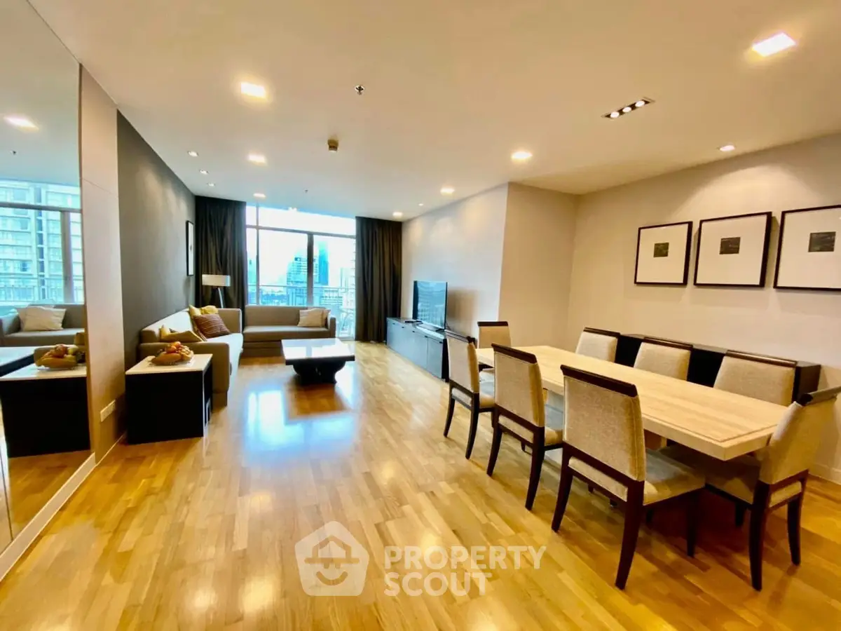 Spacious modern living room with elegant dining area and city view.