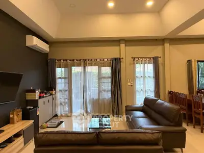 Spacious living room with modern furniture and large windows for natural light.