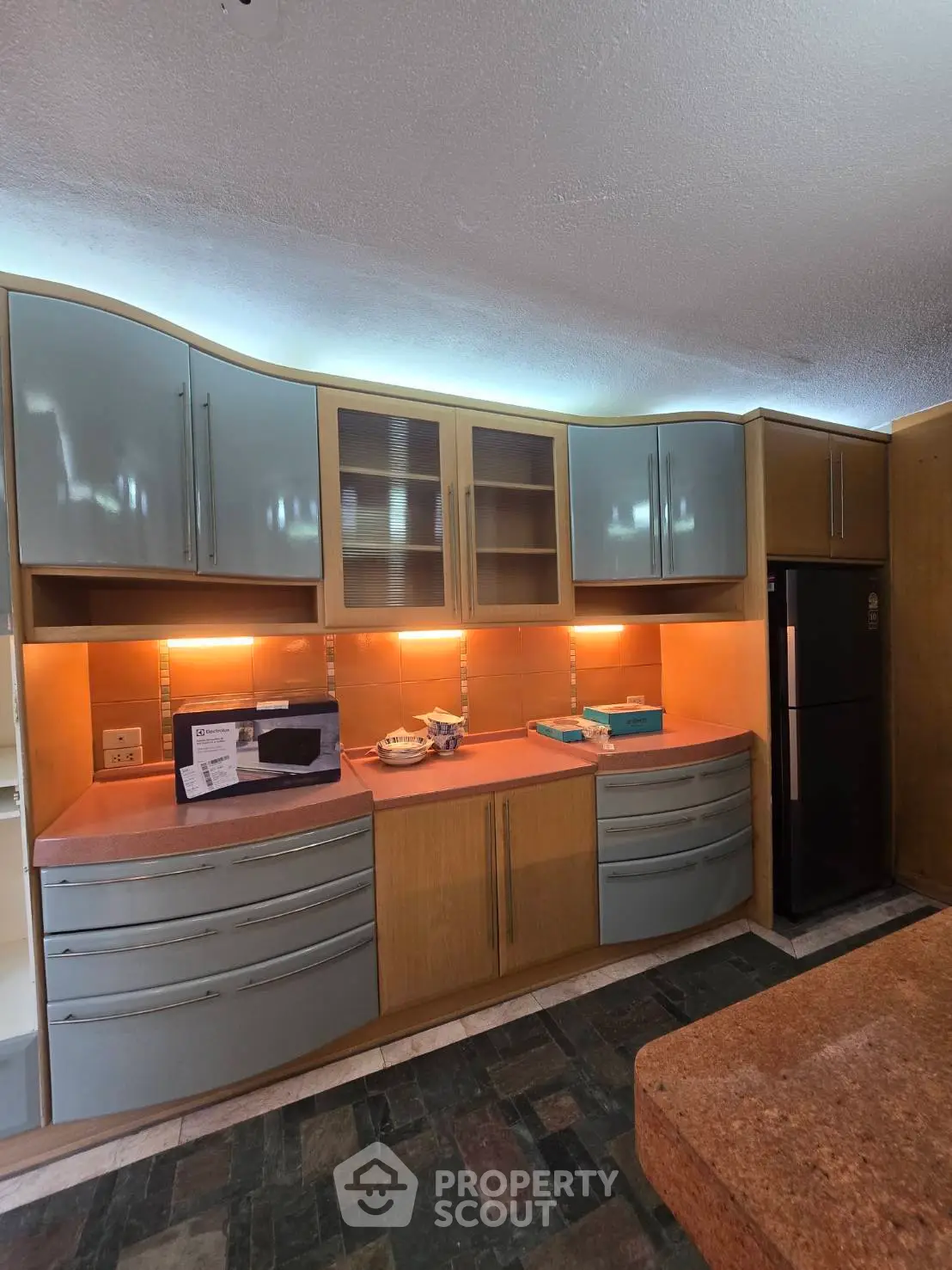 Spacious kitchen with modern cabinetry and sleek appliances, perfect for culinary enthusiasts.