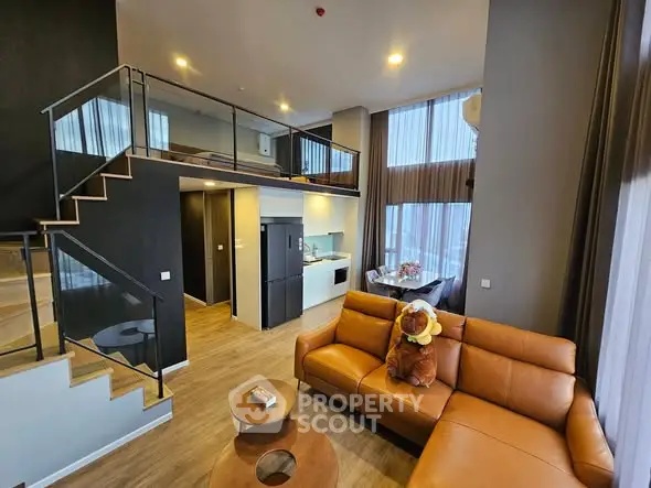 Modern loft apartment with open living area and stylish staircase
