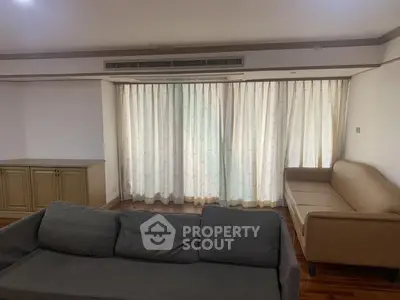 Spacious living room with elegant curtains and comfortable seating
