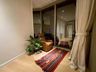 Cozy corner with armchair and plants in modern apartment with large windows.
