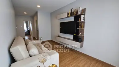 Modern living room with stylish wall-mounted TV unit and cozy beige sofa