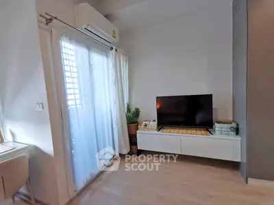 Modern living room with sleek TV setup and natural light