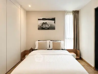 Modern bedroom with minimalist decor and large window for natural light