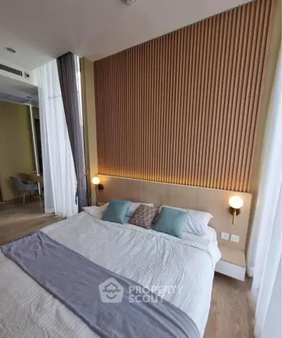 Modern bedroom with stylish wood paneling and cozy bedding in a contemporary apartment.