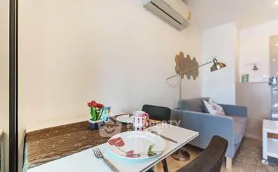 Cozy living room with dining area and modern decor in a stylish apartment.