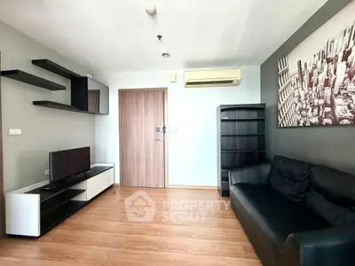 Modern living room with sleek furniture and wall art in a cozy apartment.