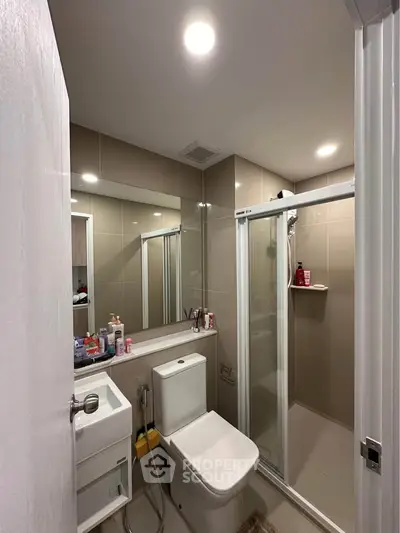 Modern bathroom with sleek shower and contemporary fixtures in a stylish apartment.