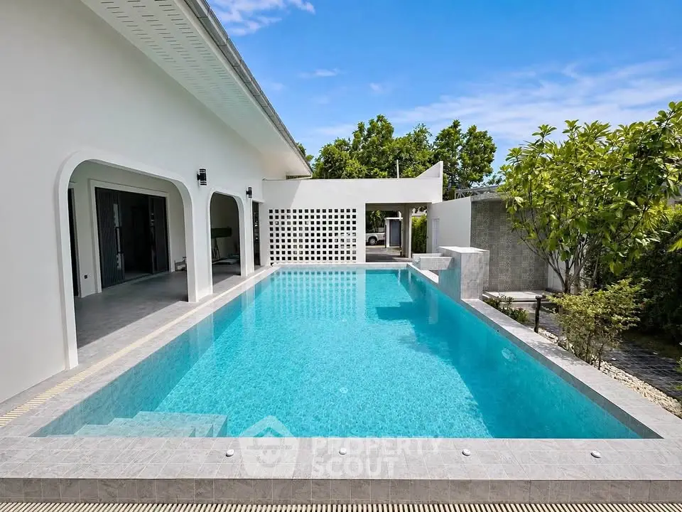 Luxurious modern villa with stunning private pool and lush greenery, perfect for relaxation and entertainment.