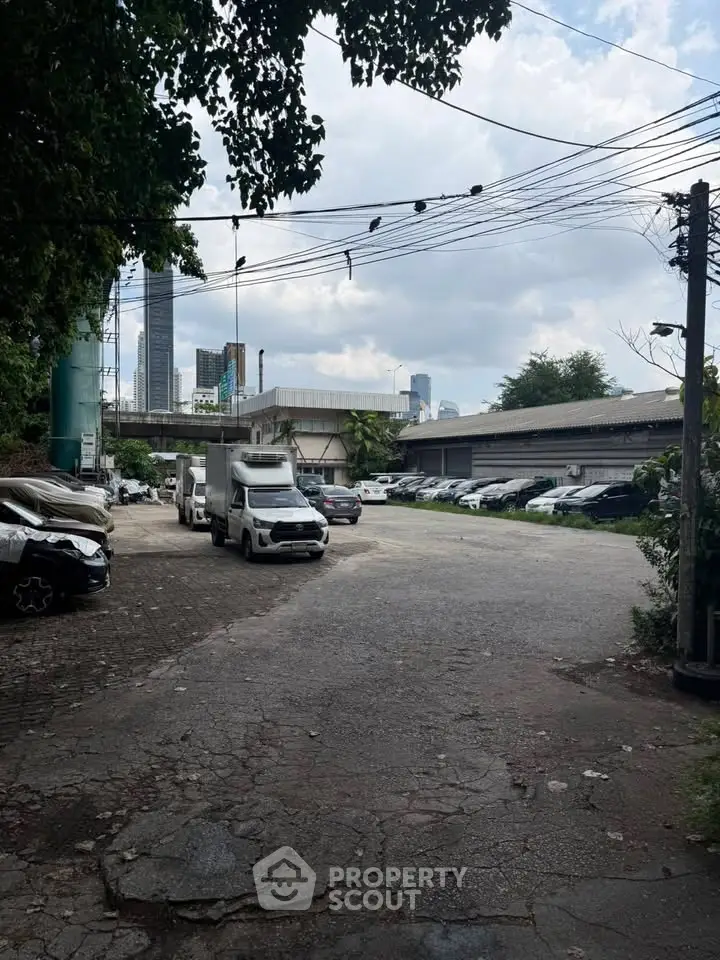 Spacious parking area with city skyline view, ideal for urban living convenience.