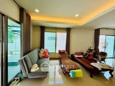 Spacious living room with modern decor and large windows offering natural light.