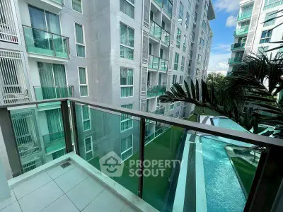 Modern apartment balcony with pool view in urban setting
