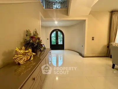 Elegant entrance with glossy floors and decorative console in luxurious home
