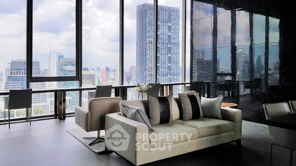 Luxurious living room with panoramic city views and modern furnishings in a high-rise apartment.