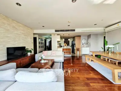 Spacious living room with elegant wooden flooring and modern decor in a luxury apartment.