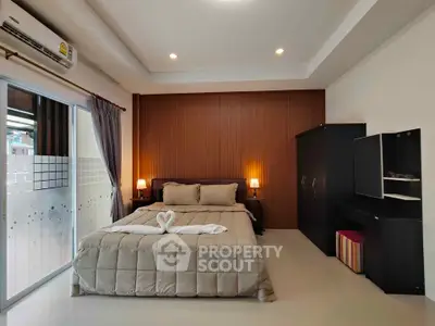 Spacious bedroom with elegant decor and natural light, featuring a cozy bed and modern furnishings.