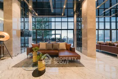 Luxurious modern living room with floor-to-ceiling windows and elegant decor in high-rise building.