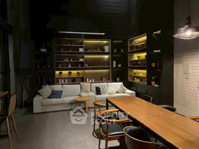 Modern living room with stylish furniture and ambient lighting, perfect for cozy gatherings.