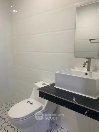 Modern bathroom with sleek white tiles and stylish sink