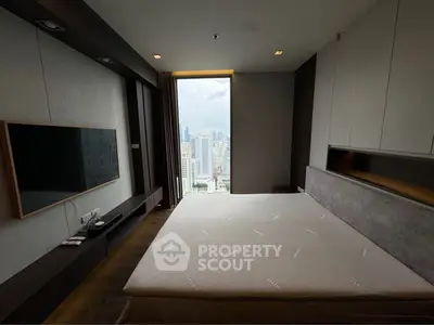 Luxurious bedroom with stunning city view and modern amenities.